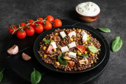 Imagen de archivo de un plato de lentejas con verduras. DEPOSITPHOTOS