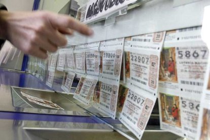 Persona elige un décimo en una administración de Lotería.