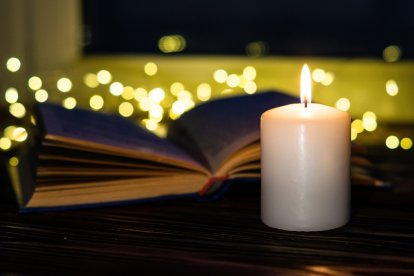 Old book and canleflame