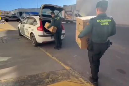Agentes de la Guardia Civil con la mercancía recuperada.