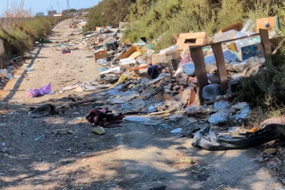 Acumulación de basura, muebles y escombros entre el Sector 20 y la rambla del Andarax