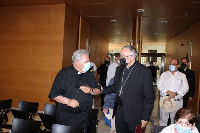 El obispo coadjutor saludando al vicario general saliente.