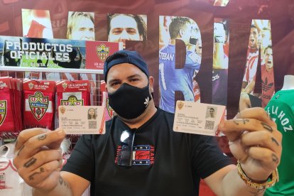 Jose Montoya muestra dos abonos desde la tienda del Almería.