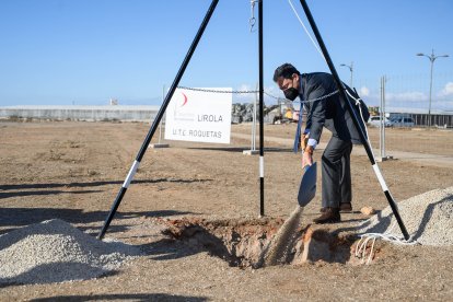 El presidente de la Junta de Andalucía echando tierra sobre la urna.