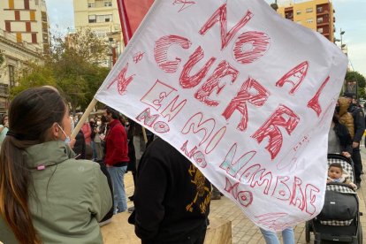 Una almeriense porta una bandera con el lema No a la Guerra.