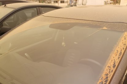 Vehículos y calles cubiertas de polvo en Adra (Marina Ginés).