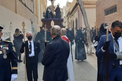 La presidencia de la procesión y al fondo el paso.