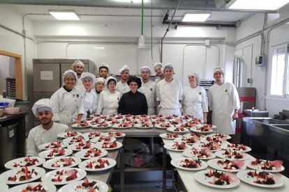 Al fondo la profersora, Visitación Miras y sus alumnos junto al centenar de platos emplatados con el postre de San Valentín.