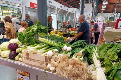 Atendiendo con felicidad a los clientes que se acercan al puesto.