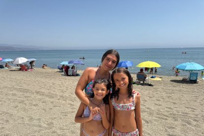 María José, monitora de Decroly Kids, posando sonriente con Julia y Mia.