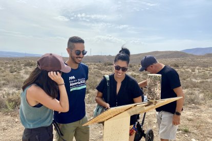 Una familia observa uno de los paneles informativos del yacimiento.