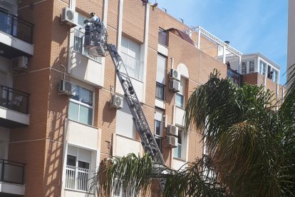 Los bomberos entran por una de las ventanas de la vivienda.