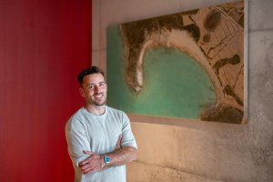 Álvaro Varela (Litoris Pictor), junto a su obra de la Playa de Genoveses, recién instalada en la sede de Cajamar.