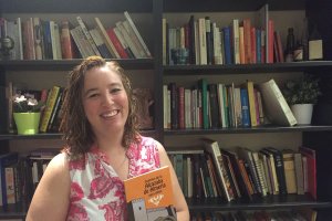 María Campra muestra un ejemplar de su primer libro en Café Cyrano.