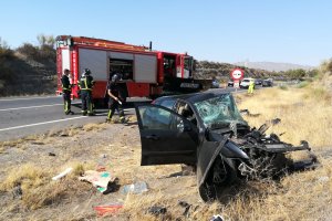 Los Bomberos de Almería junto a uno de los vehículos siniestrados.