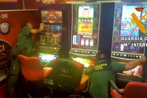 Agentes inspeccionan las tragaperras en el local.