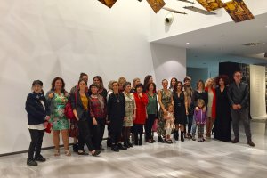 El grupo de artistas de la muestra posaban junto a las poetas y los organizadores.