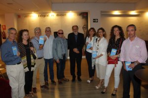 El autor (en el centro), rodeado por amigos con ejemplares de su  libro.