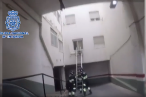 Bomberos colocan la escalera por la que agentes de la Policía Nacional acceden.