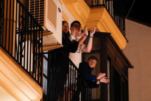 Una familia aplaudiendo ayer desde el balcón, que ha pasado a ser el catalejo desde el que se avizora la poca vida del exterior.