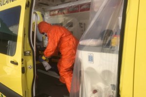 Un operario limpia y desinfecta una ambulancia.