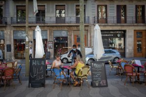 Dos mujeres comen en la terraza de un bar en Barcelona.