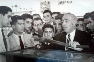 don Juan Cuadrado enseñando el célebre hacha enmangada que descubrió y regaló al Museo, a su lado Juan Miralles y otros alumnos de La Salle en 1946.