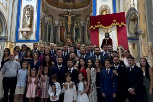 Grupo de algunos miembros de la mayordomía ante la imagen.