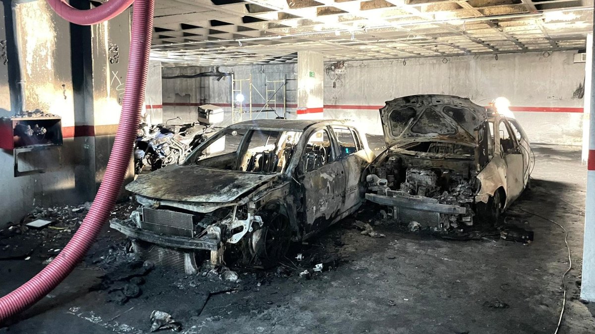 Coches calcinados en el garaje incendiado.