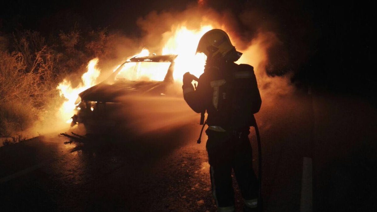 Bomberos del Levante intentan sofocar las llamas del vehículo.