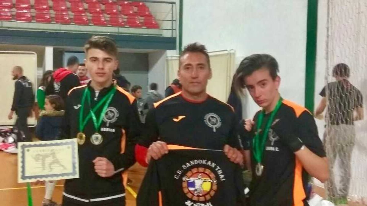 Los dos campeones con su entrenador.