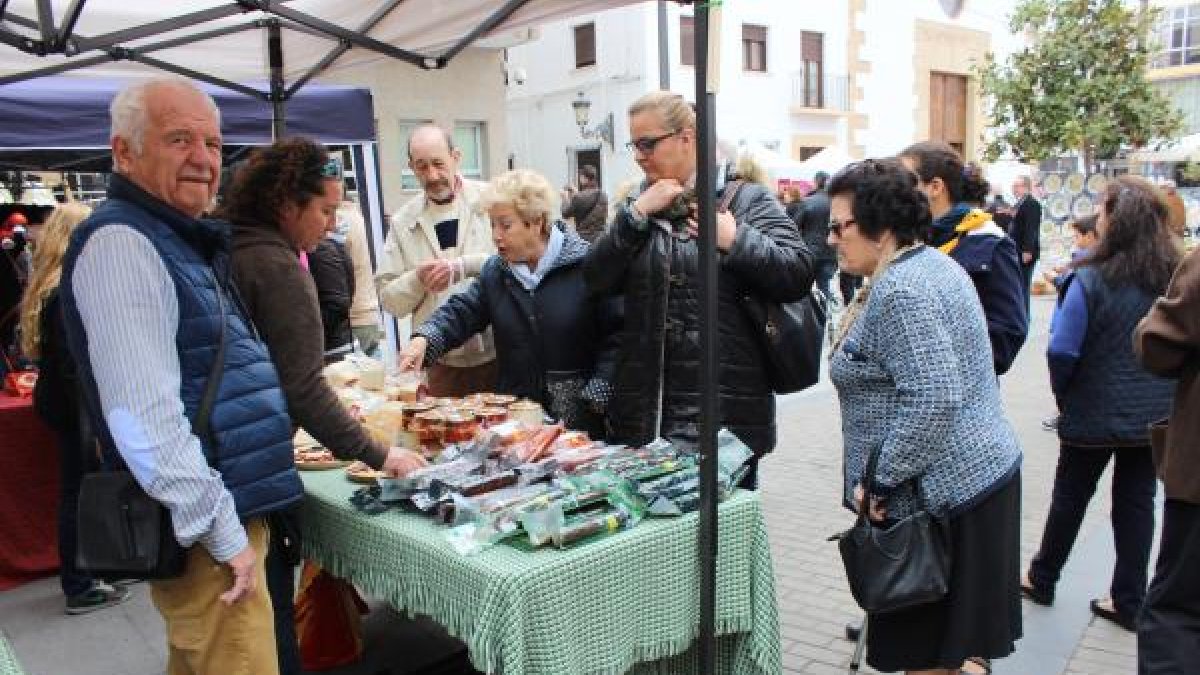 Varios visitantes se interesan por los productos gastronómicos.