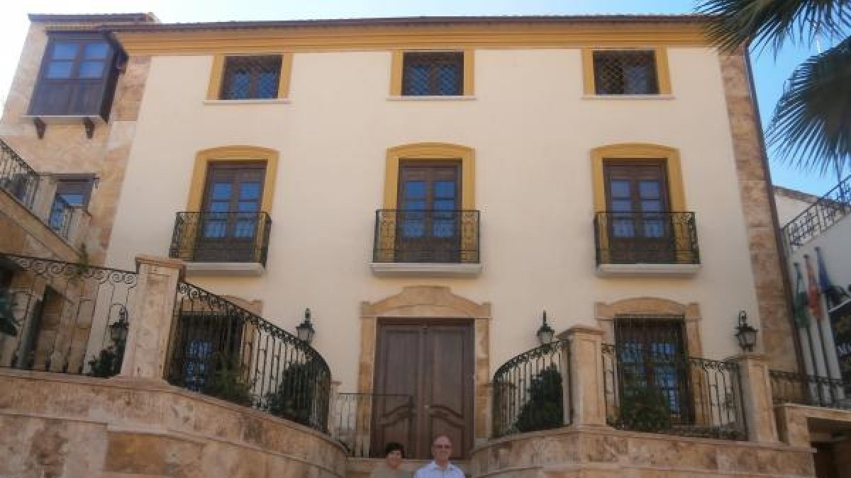 Fachada de la casa señorial con sus proprietarios