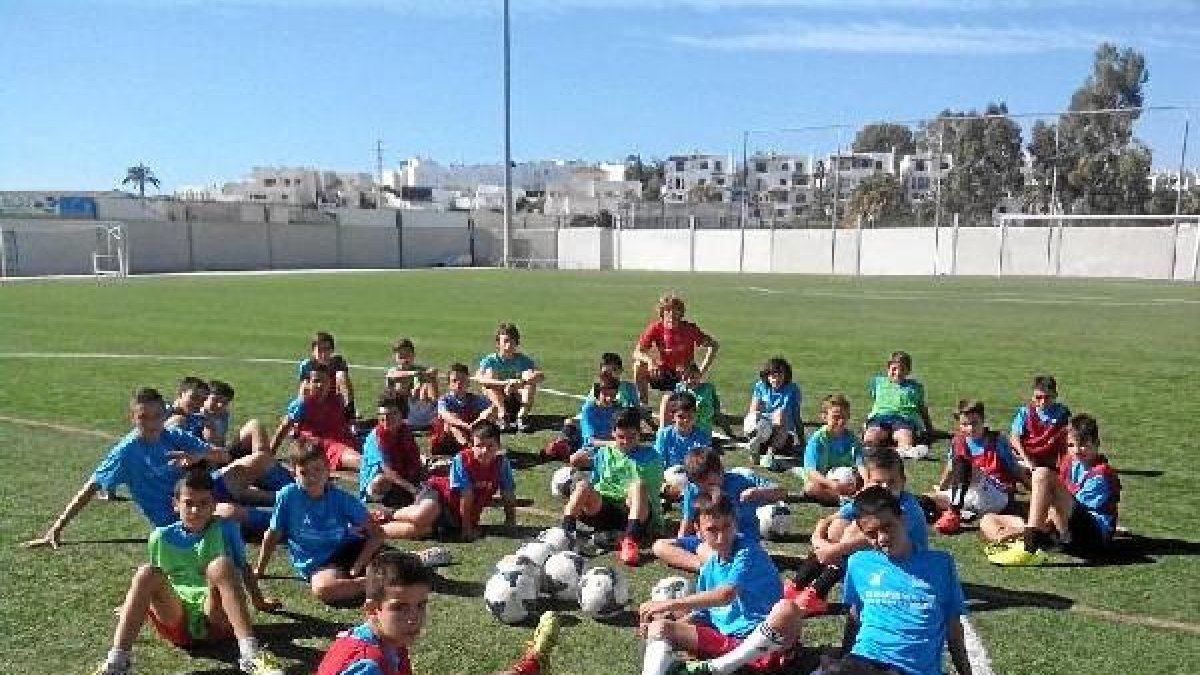Los alumnos atienden al profesor Rubén Gallardo sobre el césped.