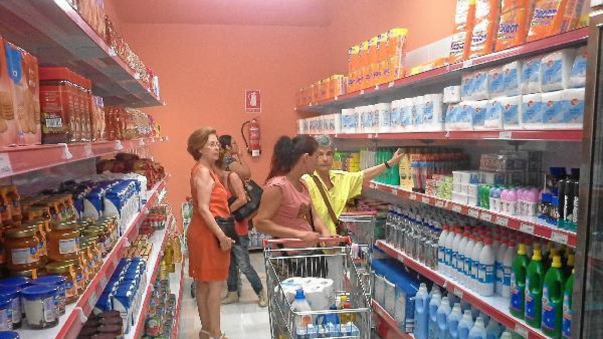 Diferentes familias comprando en el nuevo economato de Cáritas.