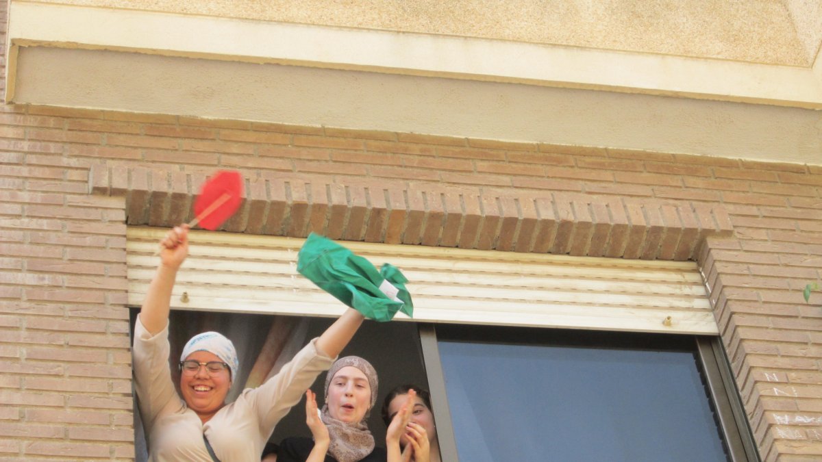 En la imagen, dos de las hijas del matrimonio saludan por la ventana tras conocerse que el desalojo se había parado.