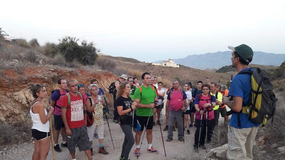 Grupo de senderistas atienden a las explicaciones del guía.