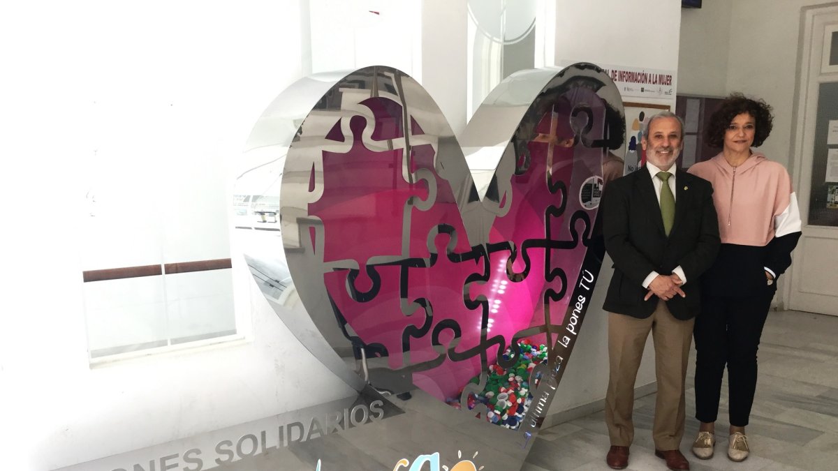 Alcalde y concejal posan junto al corazón solidario.