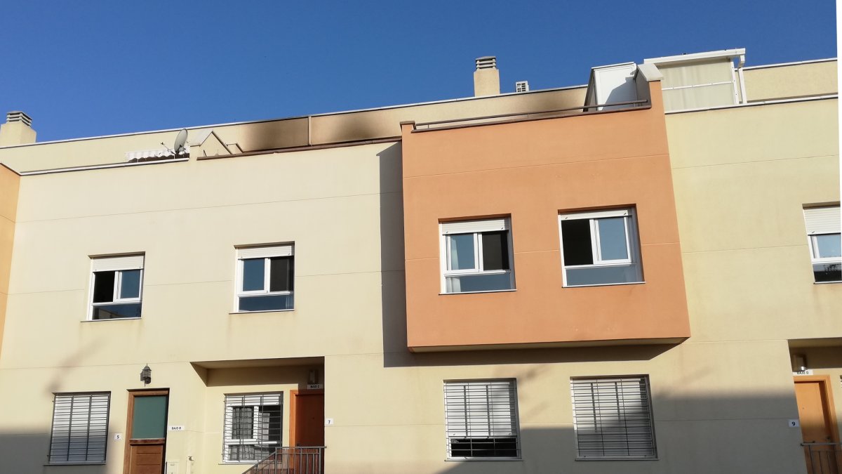 Edificio que ha sufrido el incendio con daños visibles en el ático.