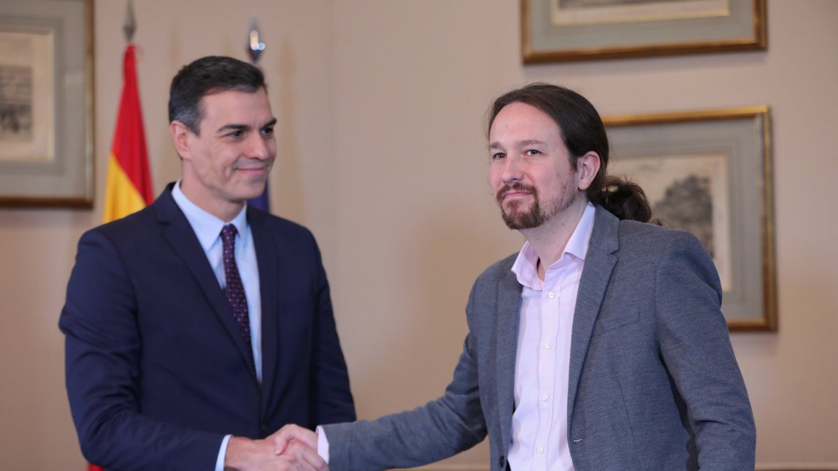 Pedro Sánchez y Pablo Iglesias se dan la mano tras anunciar su acuerdo.