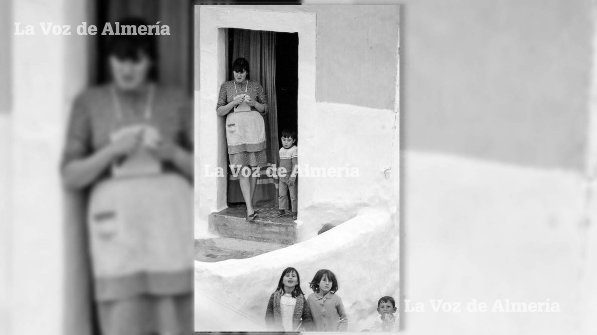 Una madre  con su mandil, pelando patatas en la puerta de su casa allá por el barrio del Reducto y vigilando a la vez a los hijos mientras jugaban.