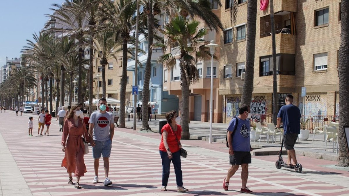 Personas con mascarilla caminando por el Paseo Marítimo de Almería.