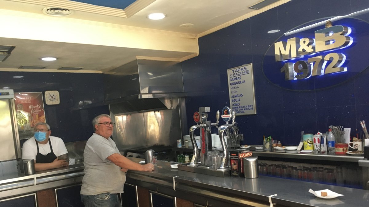 Paco con mascarilla detrás de la barra y un cliente, ayer al mediodía en el Minibar.