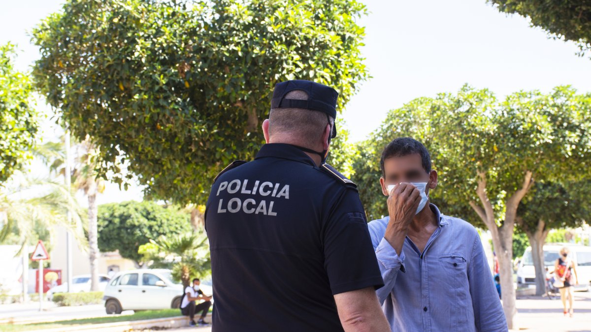 Un agente controlando el uso de la mascarilla.