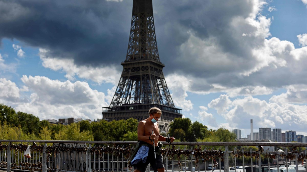 Un hombre con mascarilla hace ejercicio por las calles de París.