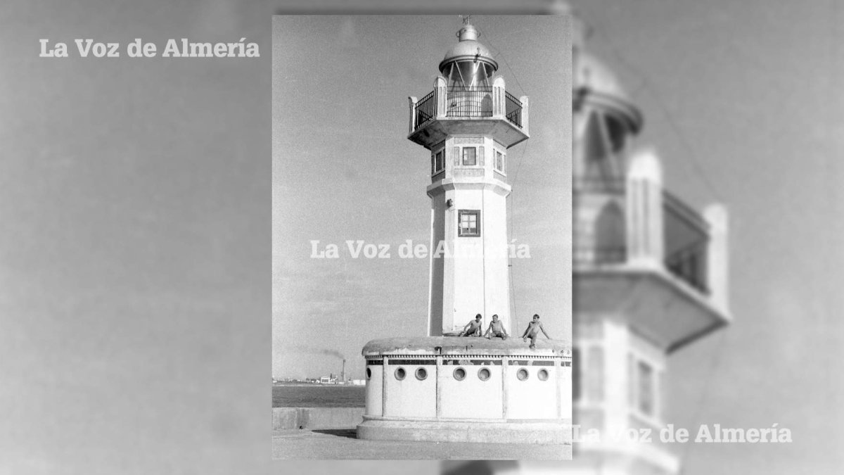 Tres adolescentes tomando el sol sobre el castillete de la base del faro de Almería.