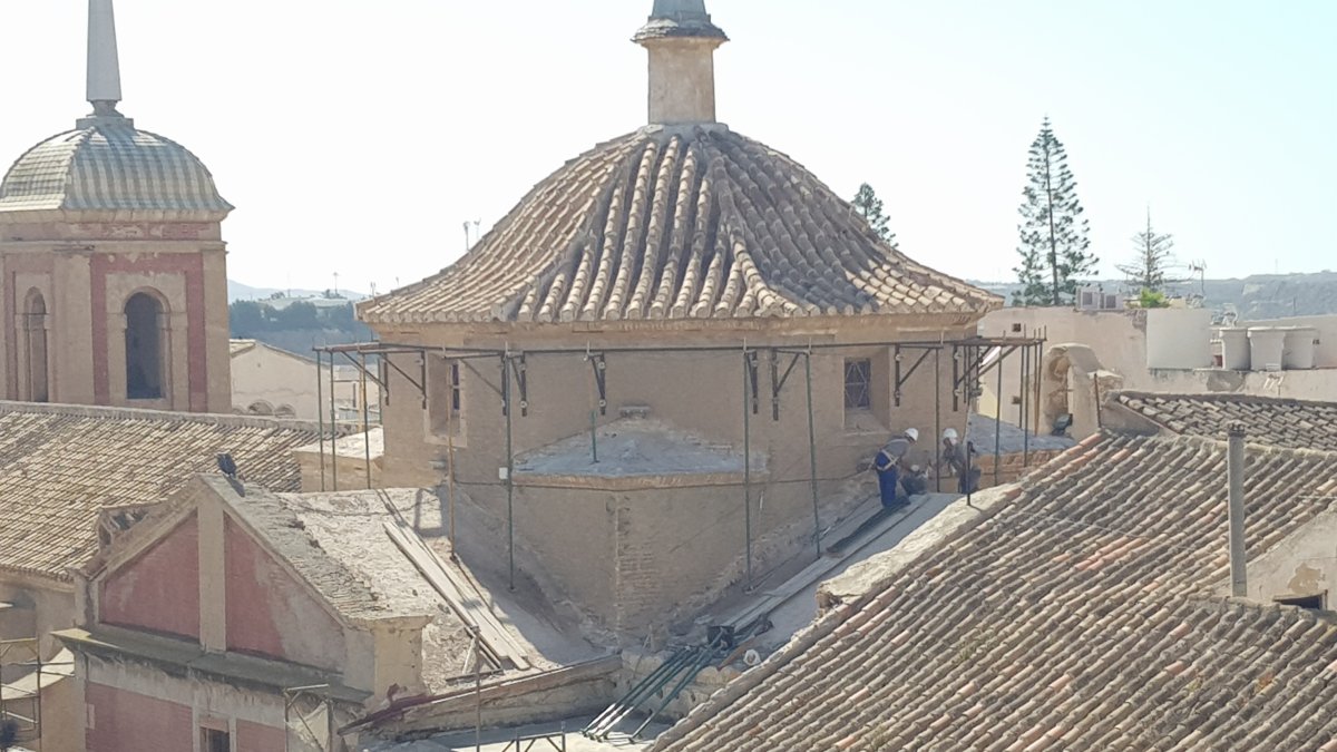 Operarios trabajando sobre la cubierta de la iglesia cuevana.