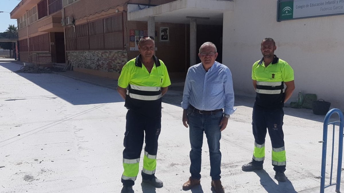 El alcalde de Vícar junto a varios operarios en el patio del colegio.