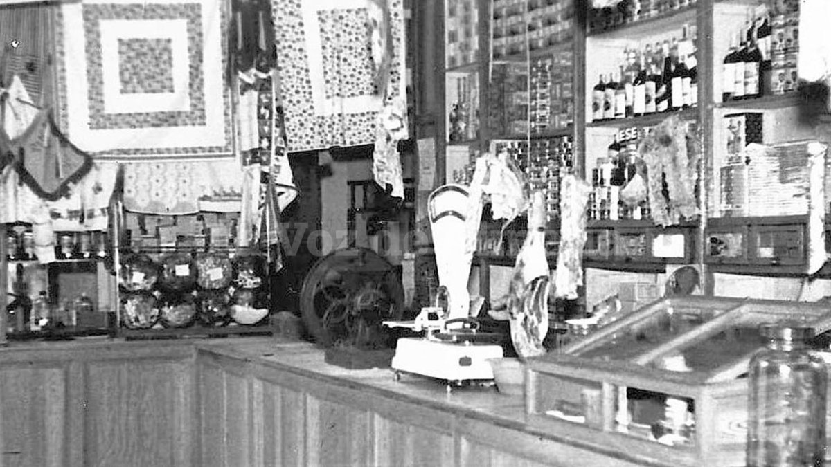 Interior de la tienda de Rafael Fenoy, con la máquina del aceite, los tarros de caramelos y los jamones colgados.