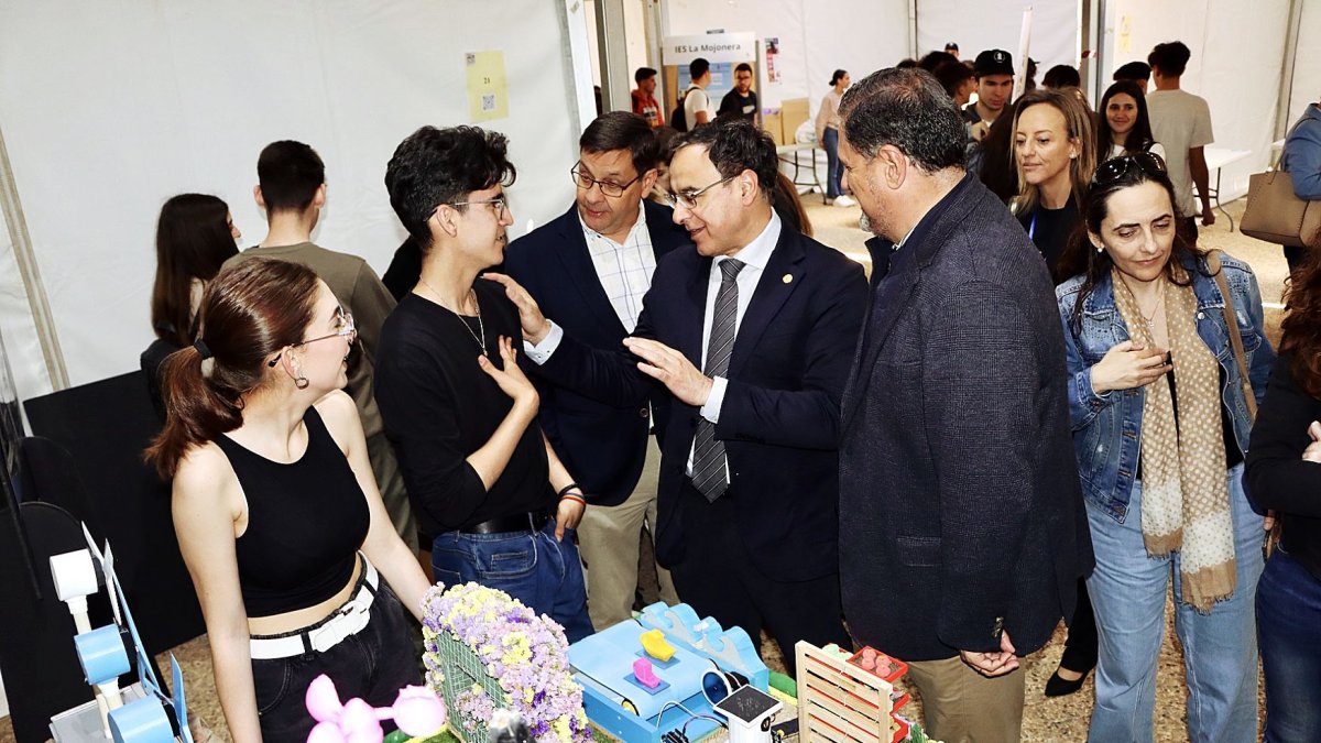 El rector y el delegado de Desarrollo Educativo charlan con algunos de los jóvenes estudiantes de Secundaria que exponen en esta feria.